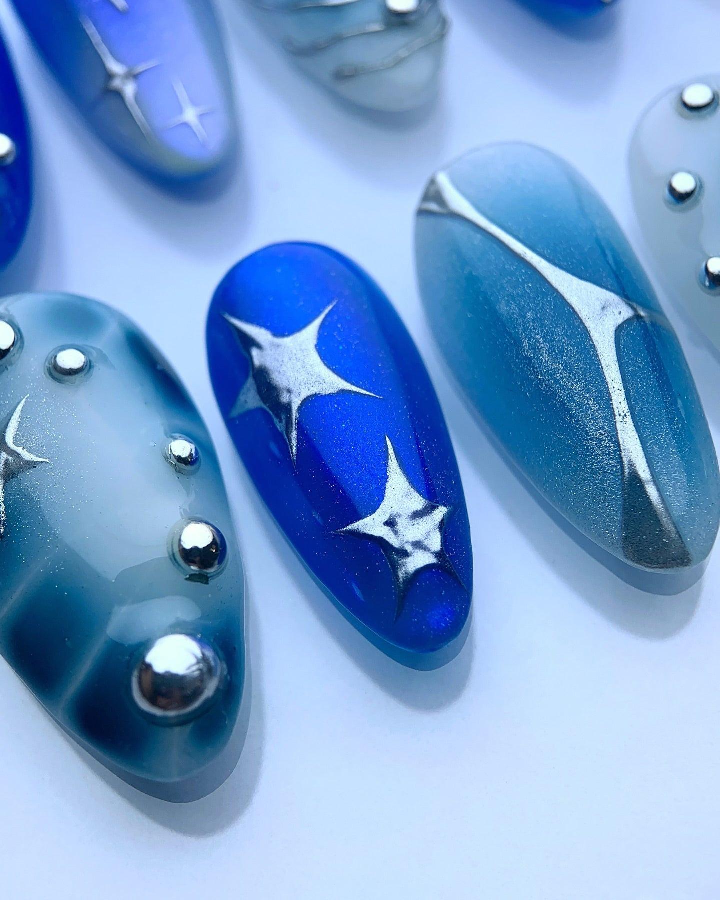 Handmade Blue Celestial Swirl Nail Art with Star Pearl Accent