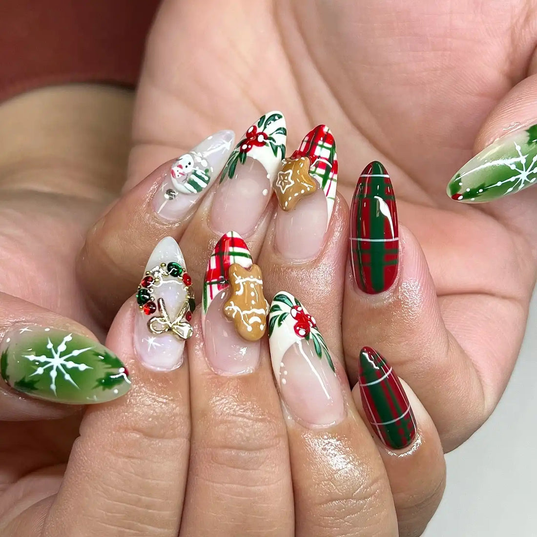 Handmade Christmas press-on nails with plaid, gingerbread, holly, wreath, and snowman designs
