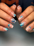Handmade press-on nails with 3D blue butterfly chrome detail on nude base