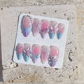 Handmade pastel press-on nails with 3D butterfly, floral, and ribbon bow designs