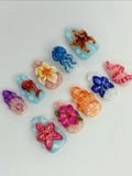 Handmade ocean reef press-on nails with 3D starfish, jellyfish, seashells, and flowers.