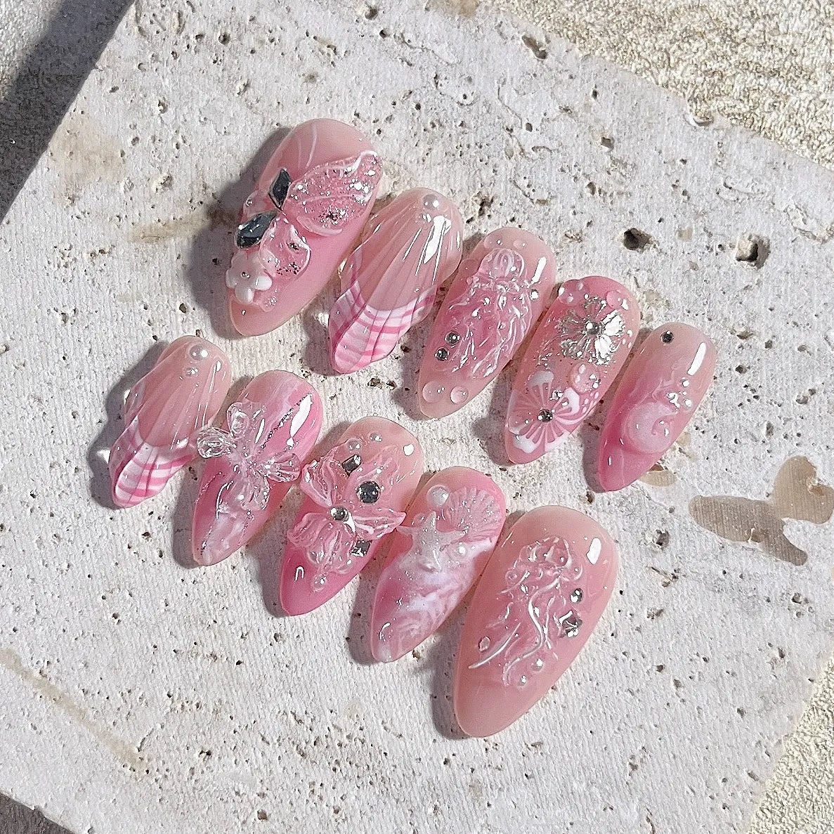 Handmade 3D pink press-on nails with butterfly, seashell, floral and pearl gem accents
