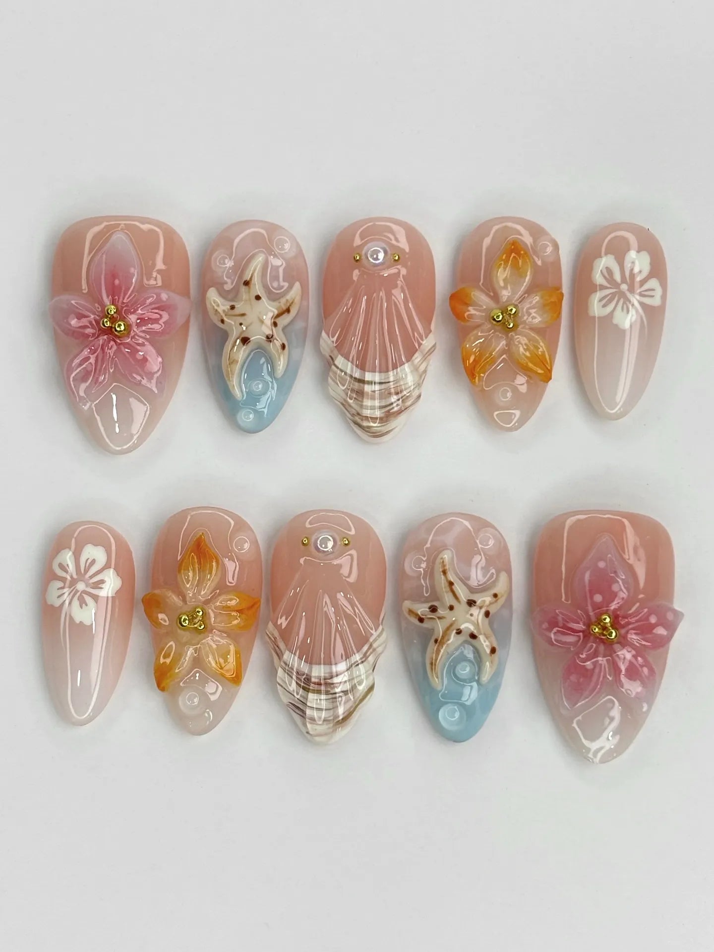 Handmade 3D tropical orchid and lily press-on nails with starfish and seashell designs on nude base