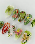 Handmade 3D press-on nails with tropical orchid and lily floral designs in green tones