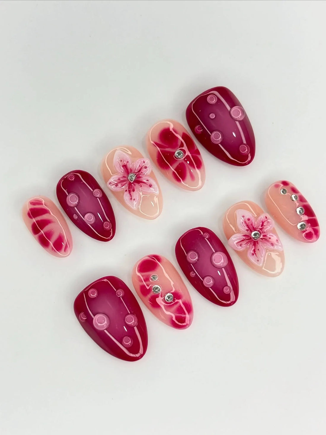 Handmade 3D press-on nails with pink floral, orchid, lily, and rhinestone accents