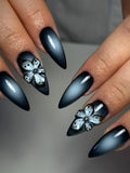 Handmade black ombre press-on nails with 3D floral accents in a chic, gothic style