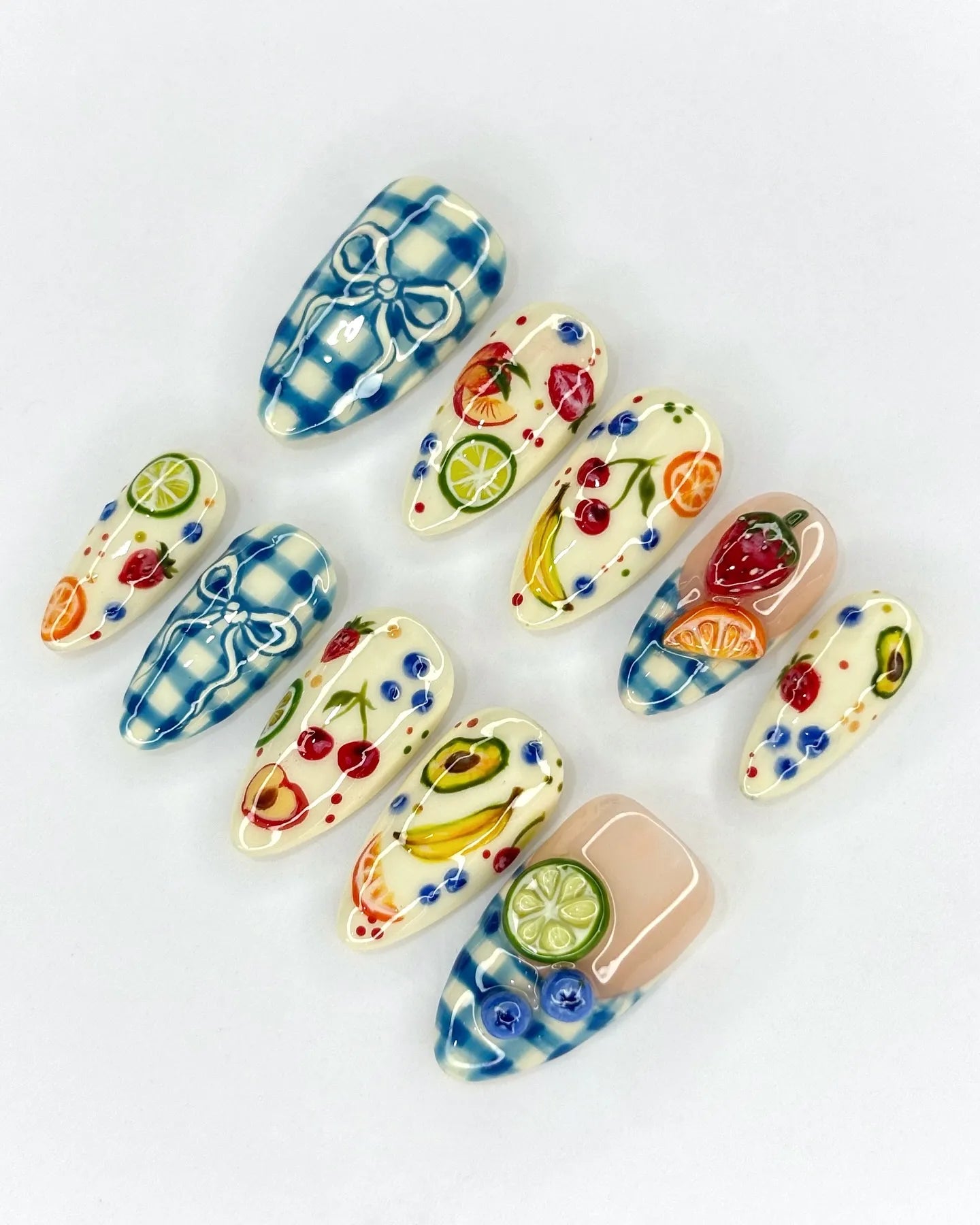Handmade press-on nails with blue gingham and colorful 3D fruit picnic designs