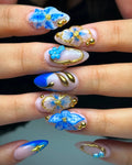 Handmade blue and gold bohemian press-on nails with 3D floral art and gold accents