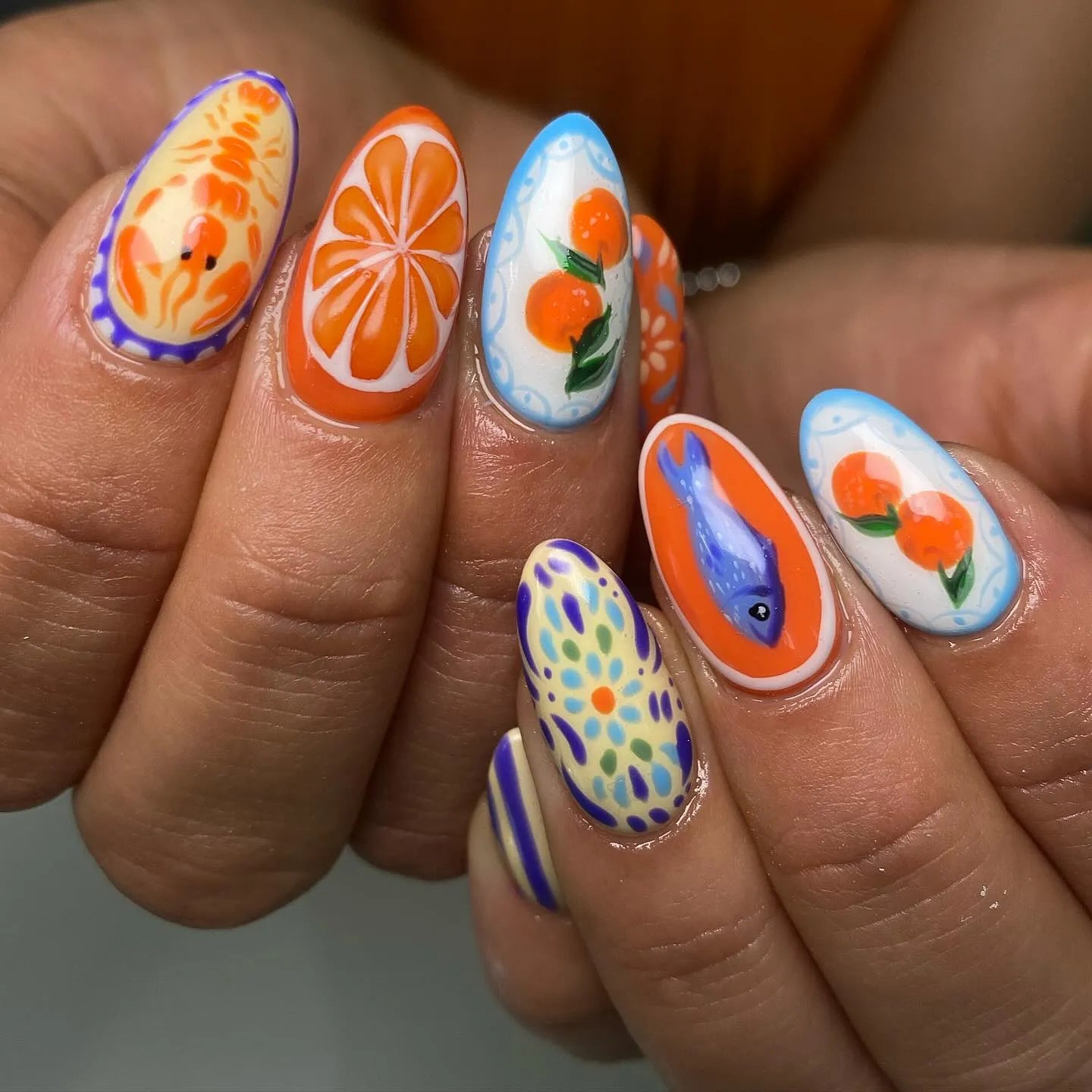 Handmade press-on nails with Mediterranean seafood and citrus designs, blue and orange summer colors.