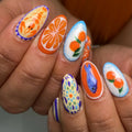 Handmade Mediterranean press-on nails with blue, orange, seafood, citrus, and fish art designs