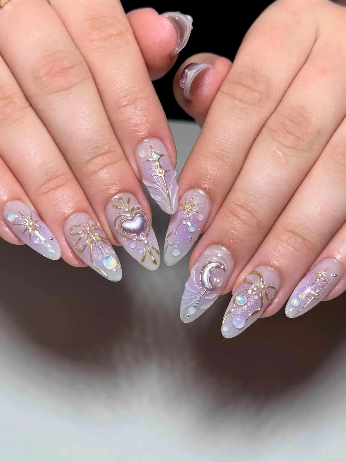 Handmade stiletto press-on nails with celestial purple heart, moon, and gold bow designs