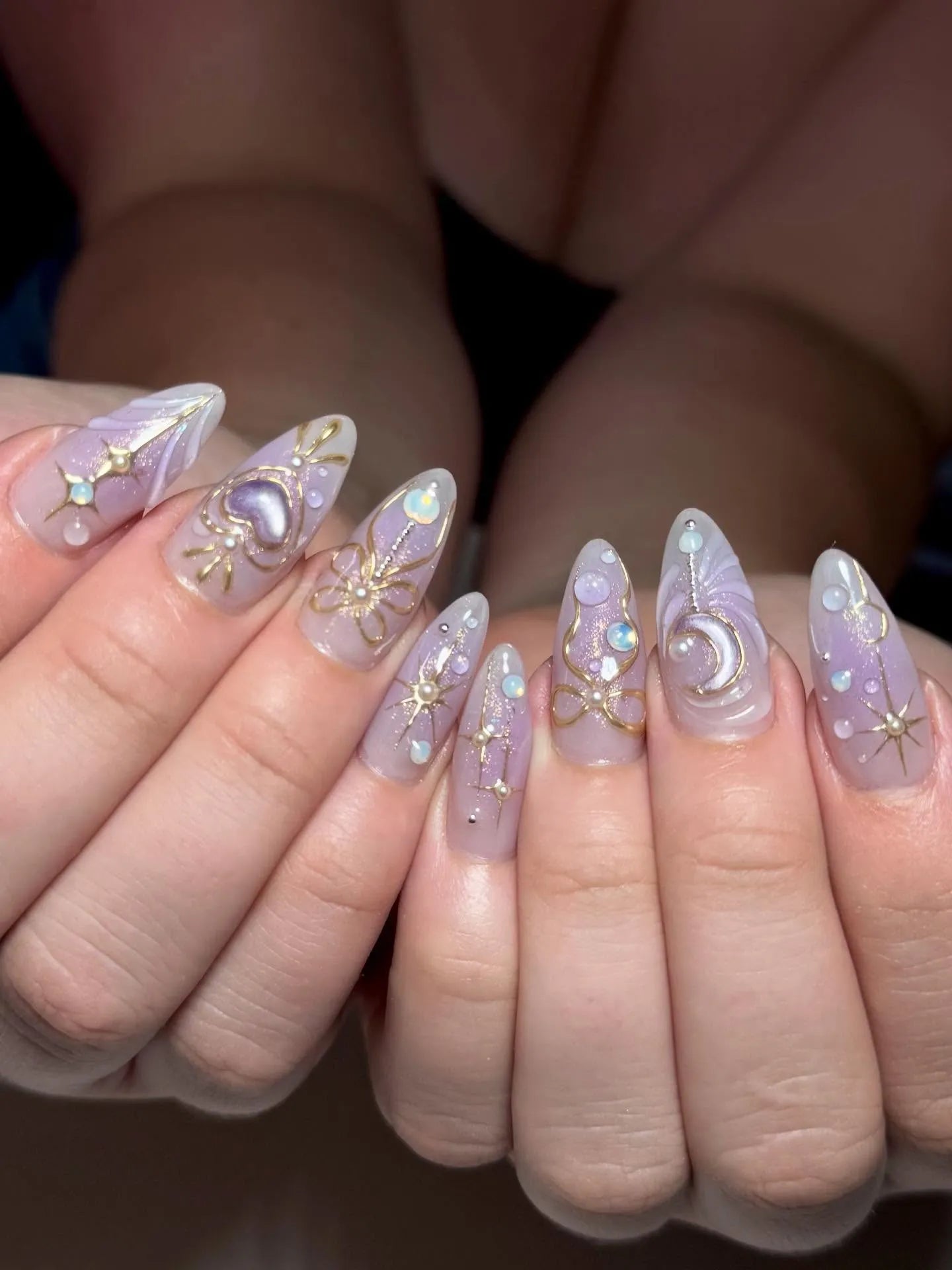 Handmade stiletto press-on nails with purple, gold celestial designs and heart accents