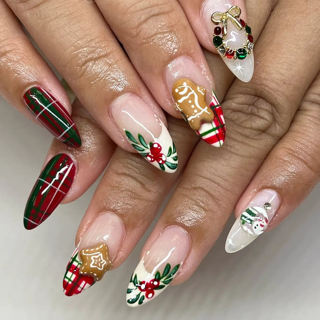 Handmade Christmas press-on nails with plaid, gingerbread, holly, wreath, and snowman designs