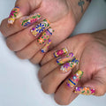 Handmade colorful floral folk art press-on nails with vibrant summer design
