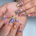 Handmade colorful floral press-on nails with vibrant folk art summer design
