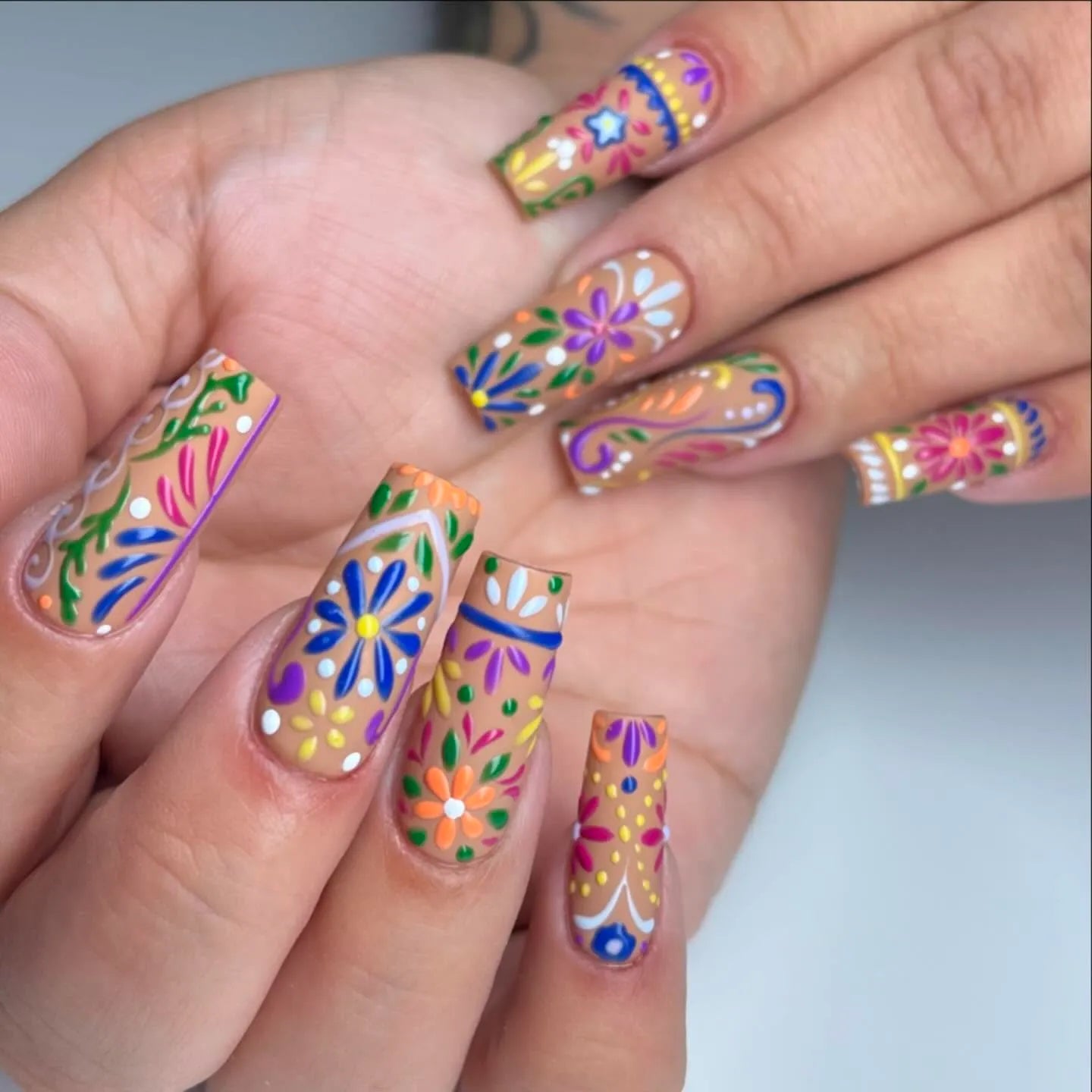 Handmade colorful floral press-on nails with vibrant folk art summer design