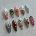 Handmade press-on nails with summer fruit, ladybug, apple, and whimsical floral designs.
