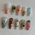 Handmade press-on nails with summer fruit, ladybug, apple, floral, and whimsical picnic designs.