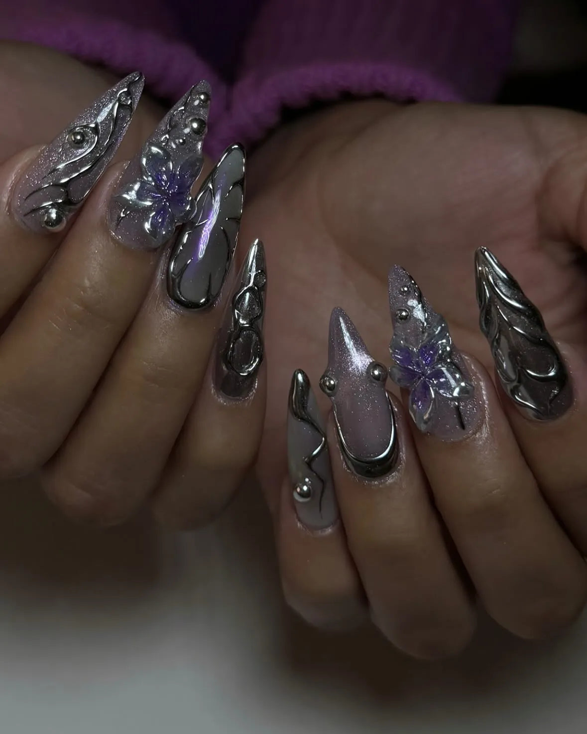 Handmade stiletto press-on nails with chrome, purple metallic flower, and 3D accents