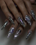 Handmade cyber chrome purple 3D metallic flower stiletto press-on nails on a hand