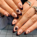 Handmade press-on nails with dark burgundy French tips, silver chrome heart and star accents.
