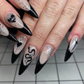 Handmade gothic press-on nails with black French tips, heart, spider web, and dagger designs.
