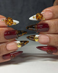 Handmade deep ruby red and tortoise shell stiletto press-on nails with 3D gemstone accents