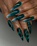 Hand with handmade emerald green stiletto press-on nails, 3D sea glass textured design