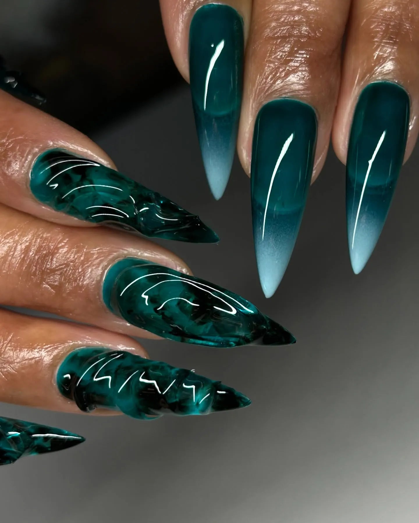 Hand with emerald green stiletto press-on nails, 3D textured and sea glass effect
