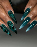 Handmade emerald green stiletto press-on nails with 3D sea glass texture and gradient effect.