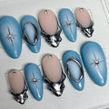 Handmade blue ombre press-on nails with metallic silver chrome and starburst accents.