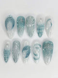 Handmade blue seafoam press-on nails with 3D starfish, shell, and glitter ocean designs.