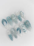 Handmade blue and seafoam press-on nails with 3D starfish, shell, and ocean designs