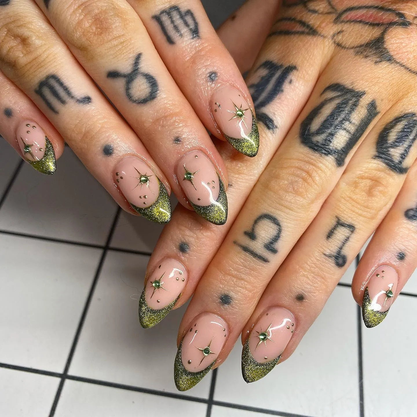 Handmade gold moss green shimmer French tip press-on nails with starburst accents