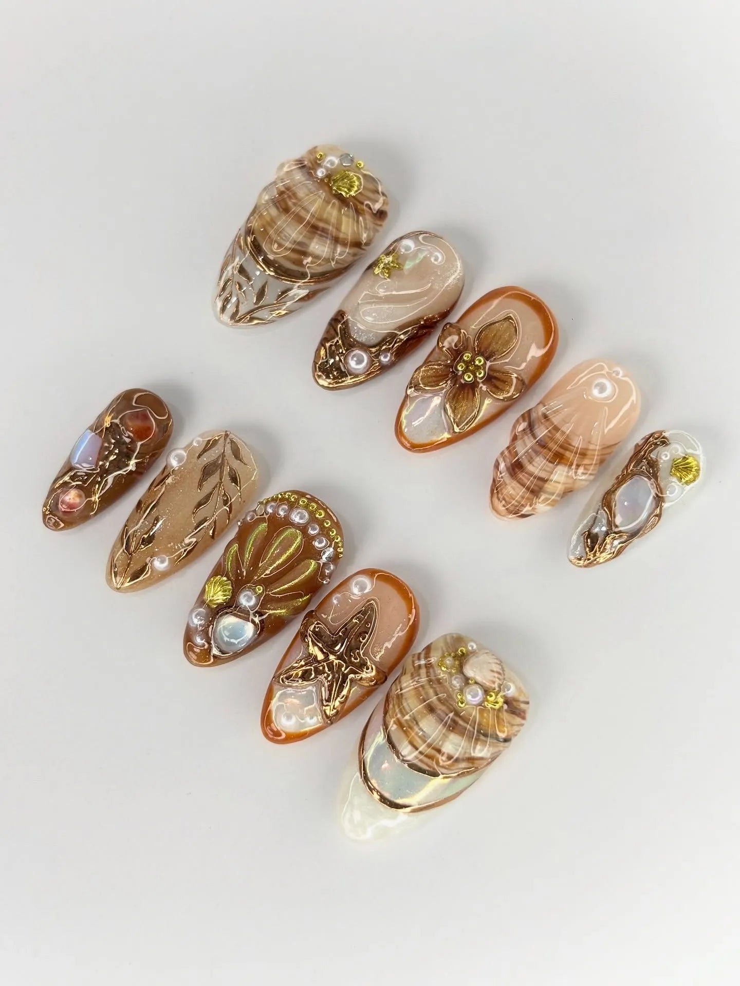 Handmade press-on nails with beach theme, gold starfish, seashell, and pearl accents