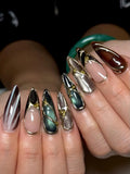 Handmade metallic stiletto press-on nails with jewel tones and gold chrome accents