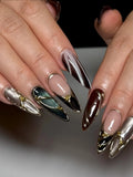 Handmade stiletto press-on nails with metallic chrome, jewel tones, and gold accents