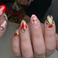 Handmade press-on nails with red sacred heart, gold dagger, and cherry gothic designs