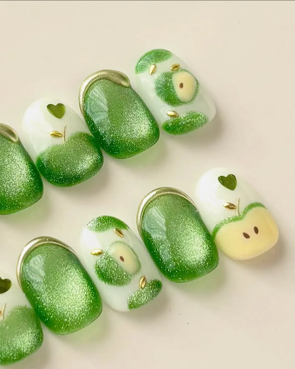 Handmade green apple cat eye shimmer press-on nails with heart and fruit designs