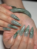 Handmade green jade marble effect extra long stiletto press-on nails on hands