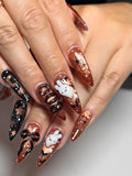 Handmade Halloween press-on nails with metallic bronze, black, ghost, bat, and 3D bow designs.