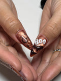 Handmade Halloween press-on nails in metallic bronze with ghost, bat, and 'BOO' 3D nail art.