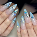 Handmade icy light blue ombre gemstone press-on nails with shimmer and crystal accents.
