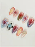 Handmade iridescent press-on nails with 3D floral designs, speckled pastel ombre finish.