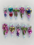 Handmade iridescent chrome 3D press-on nails with heart, star, bow, flower, and cherry designs