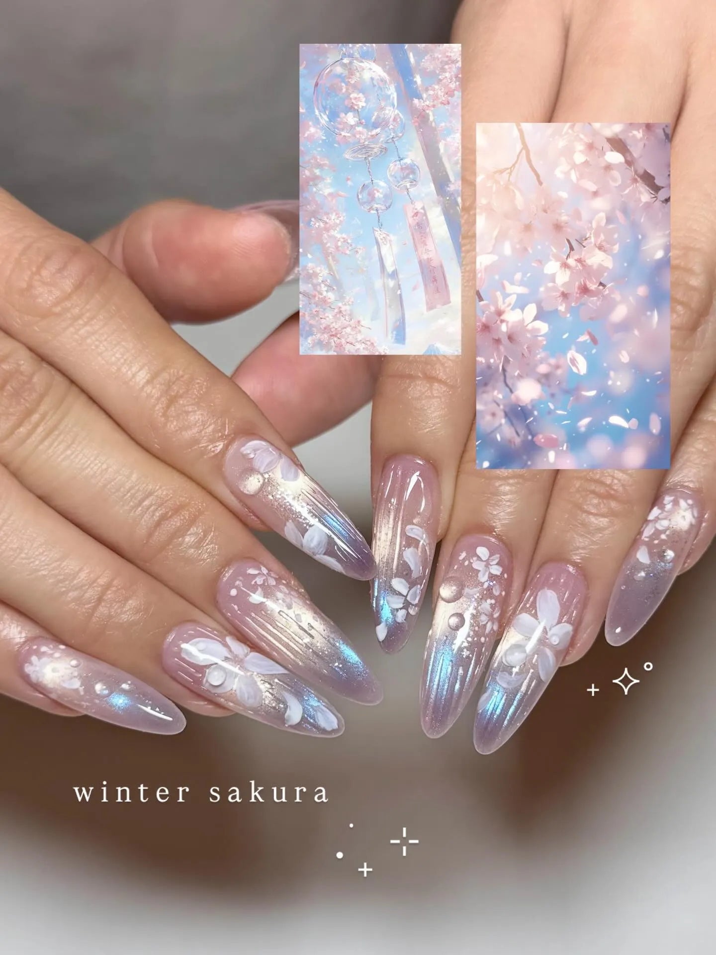 Handmade iridescent stiletto press-on nails with white floral and shimmering dewdrop design.