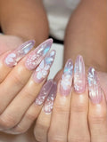 Handmade iridescent stiletto press-on nails with floral design and dewdrop accents