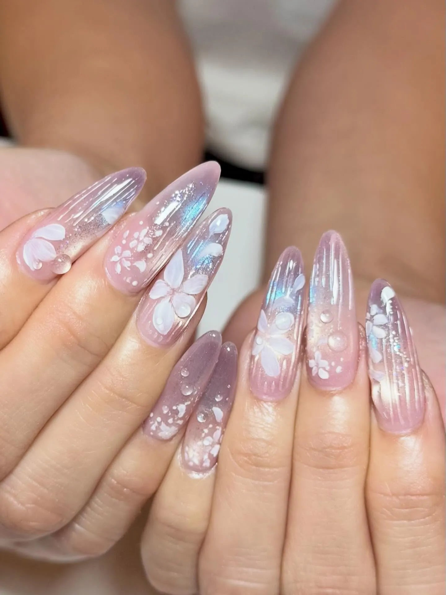 Handmade iridescent stiletto press-on nails with floral design and dewdrop accents