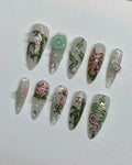 Handmade iridescent press-on nails with jade green bamboo, lotus, and snake Asian designs.