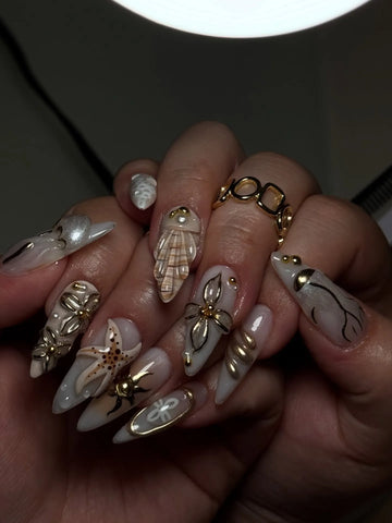 Handmade coastal press-on nails with 3D starfish, seashell, and pearl decorations